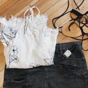 Flowy floral tank top with distressed lace inset